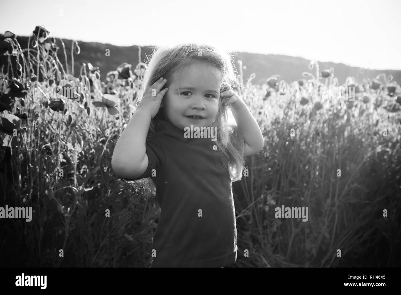 Kid Or Smiling Little Boy With Long Blonde Hair In Red Shirt In