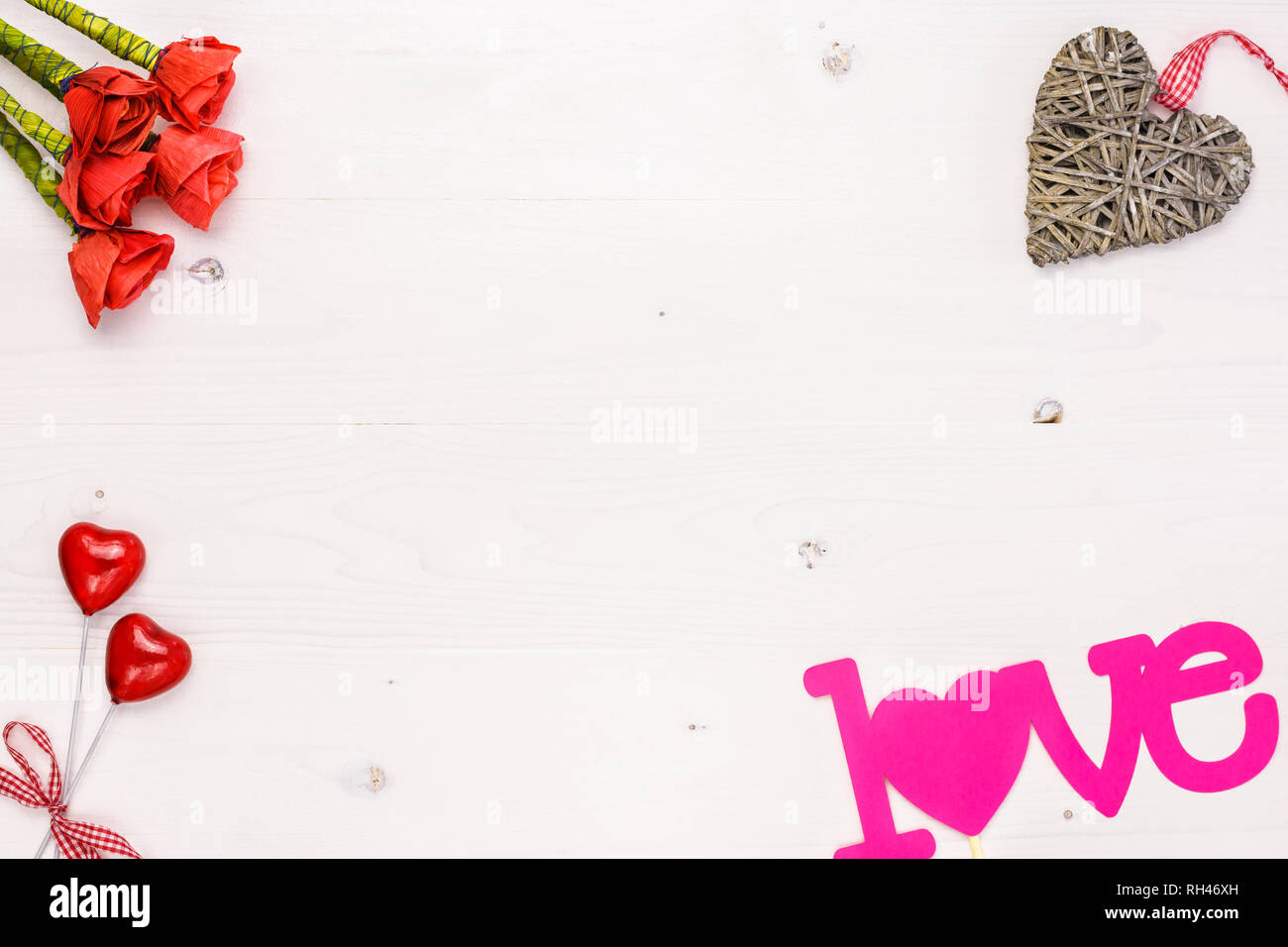Table top view image of decoration Valentines day background concept.Arrangement of artificial red roses and hearts with decorative objects on a white Stock Photo