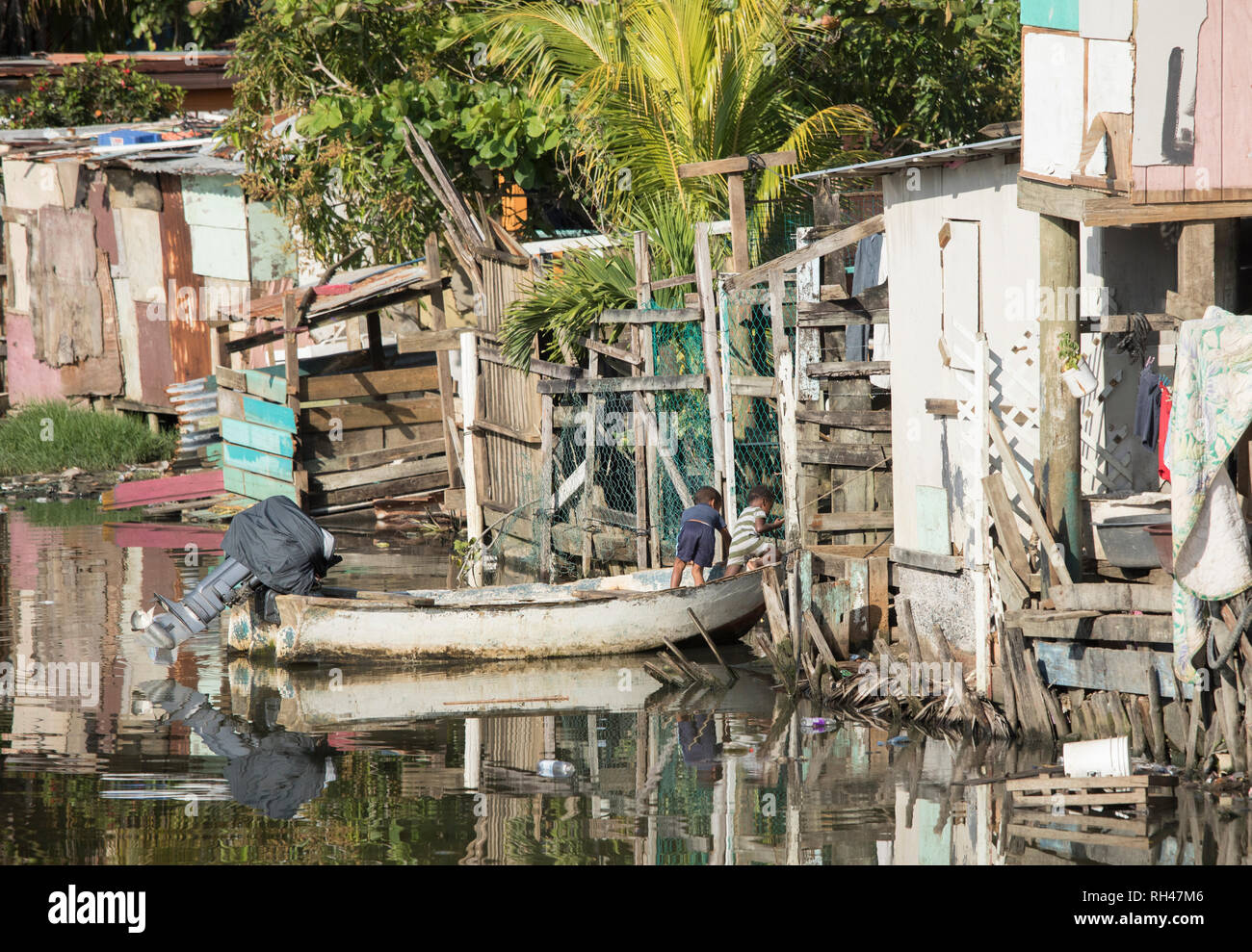 Kids play on a boat in a slum along the water in Honduras. Stock Photo