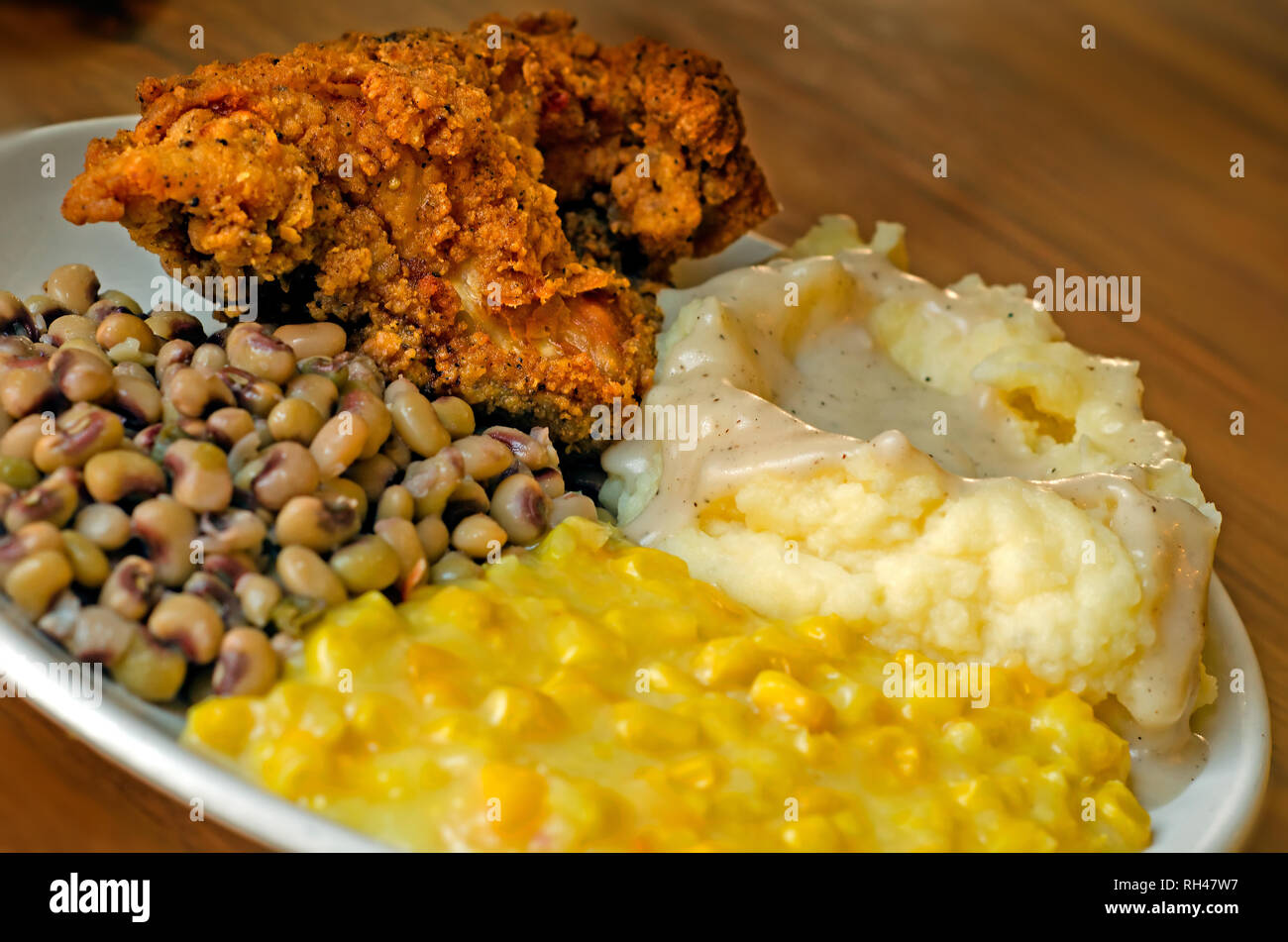 Fried chicken, mashed potatoes and gravy, blackeyed peas, and creamed