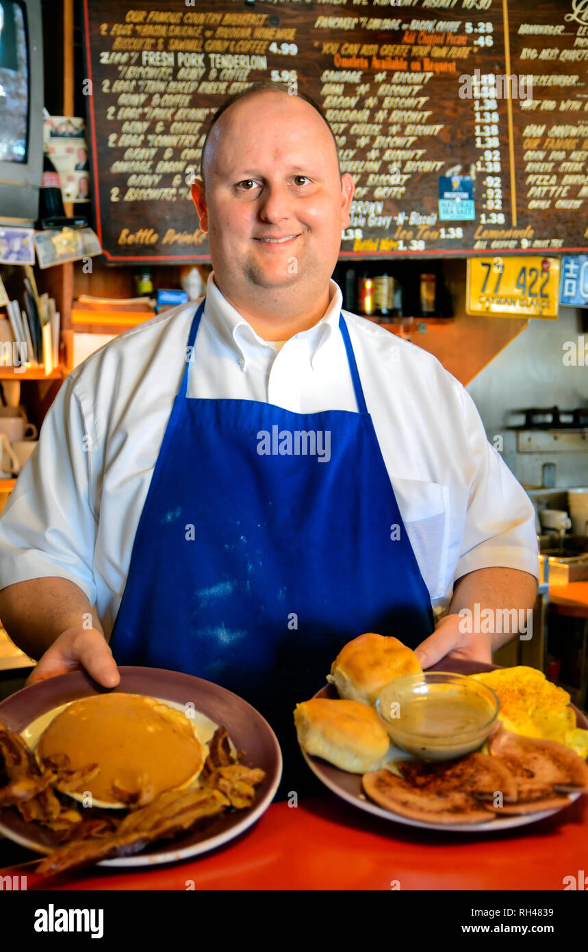 Ryan Whitfield shows off plates of breakfast foods at Abe's Grill in Corinth, Mississippi March 5, 2012. Stock Photo