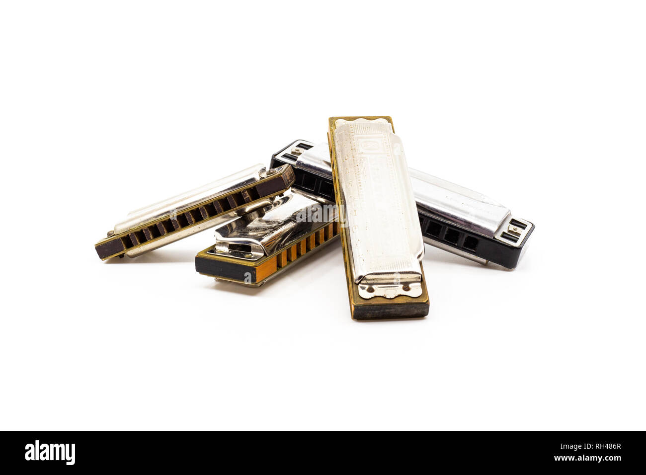 Musical instrument pile of blues harps isolated on white Stock Photo