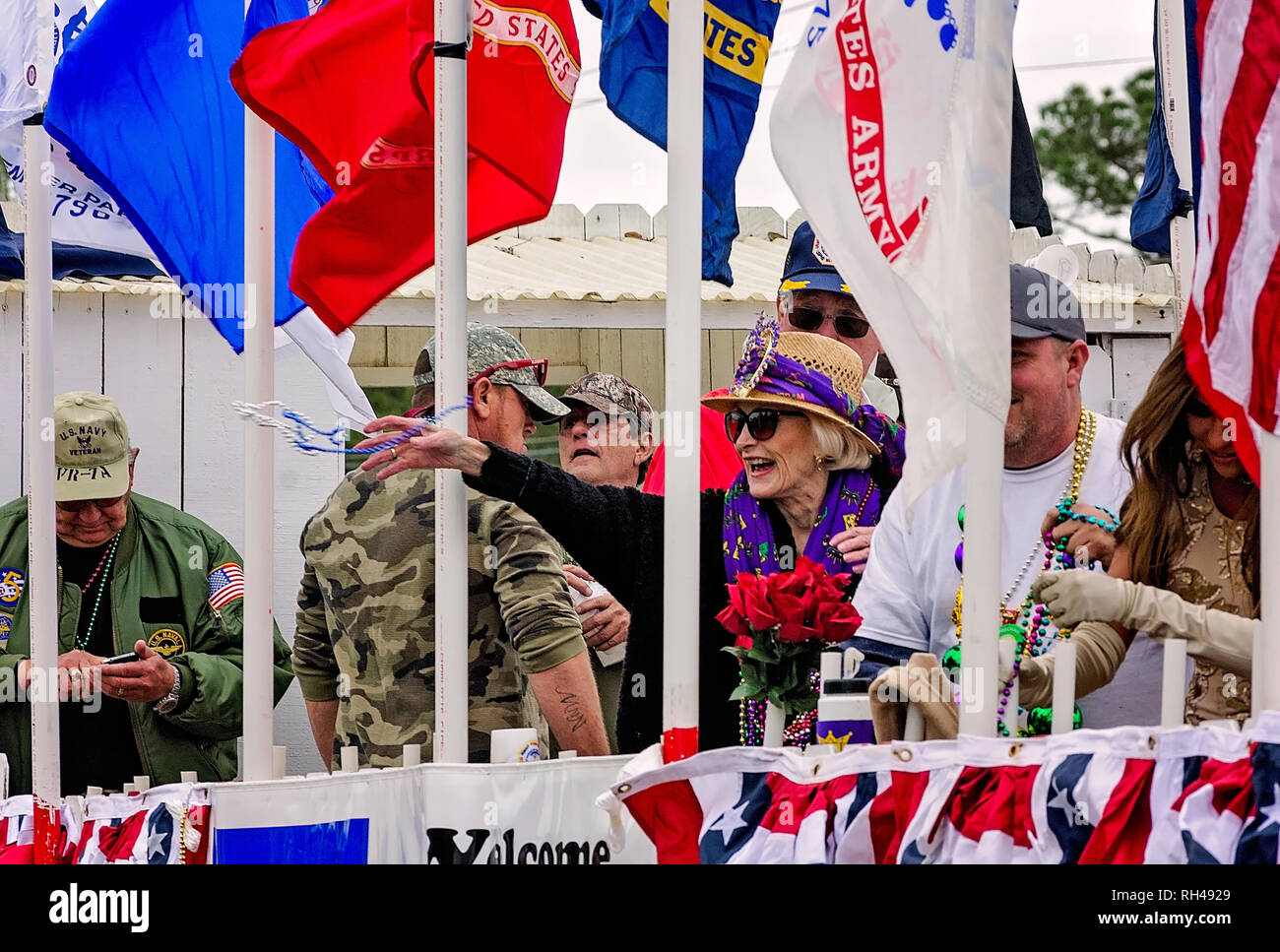Members of the Dauphin Island Veterans Association throw beads at the