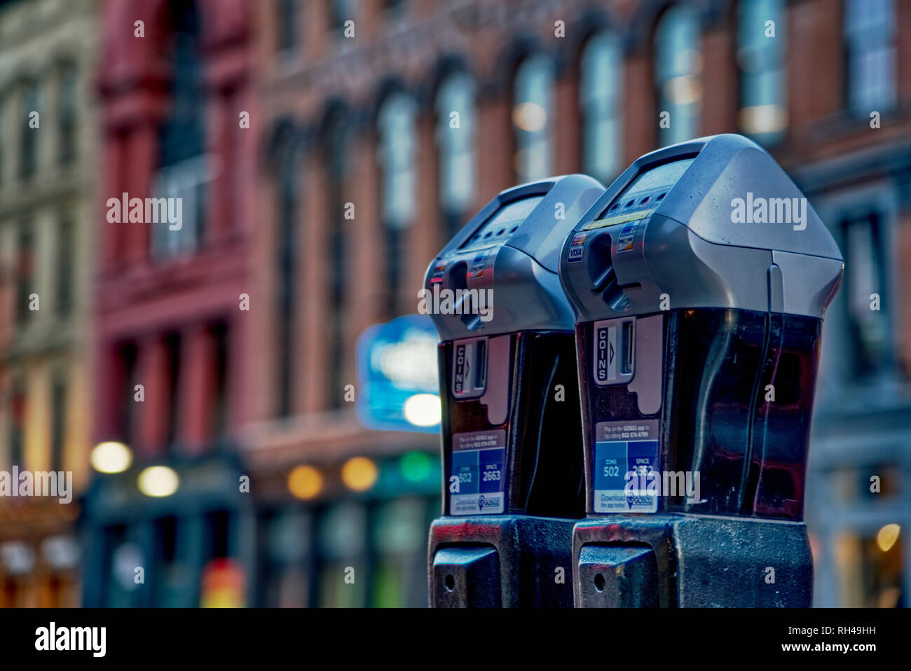 Parking meters on downtown city street Stock Photo Alamy