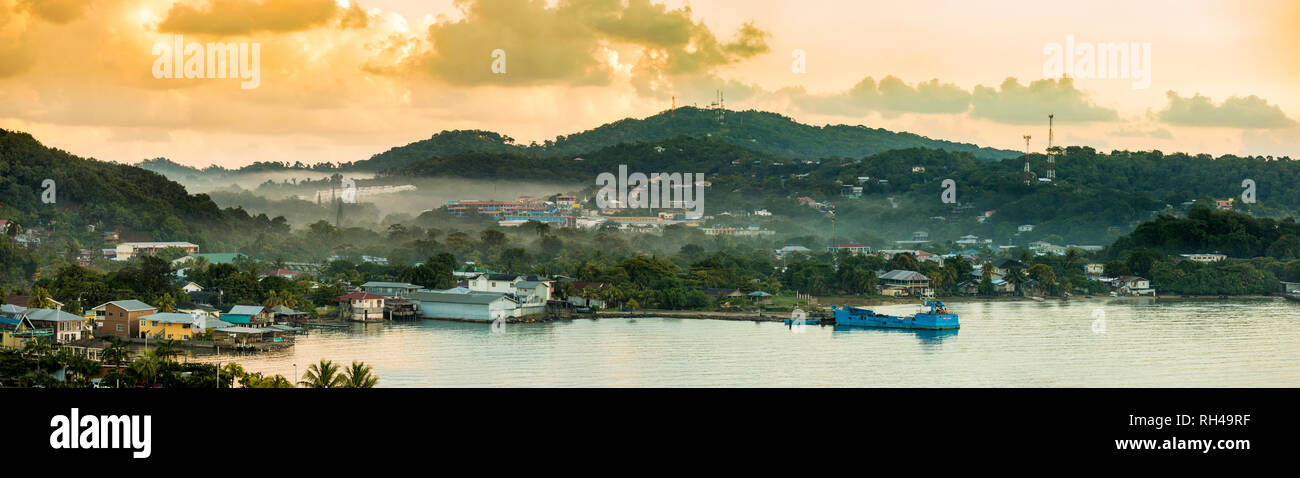 Panorama of Coxen Hole, Roatan with fog in first morning light. Stock Photo