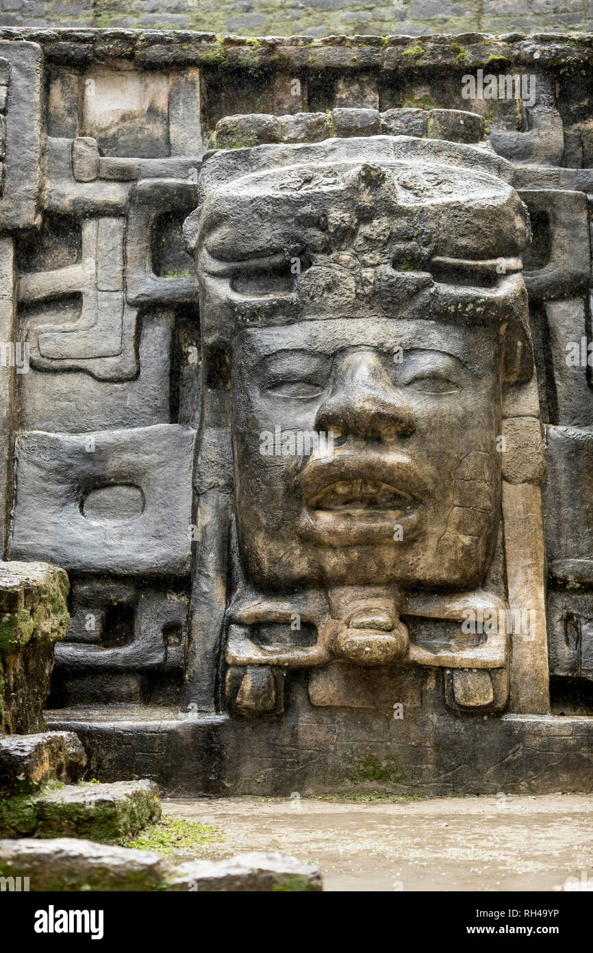 The Olmec style mask on the side of the Mayan temple of Lamanai in Belize. Stock Photo