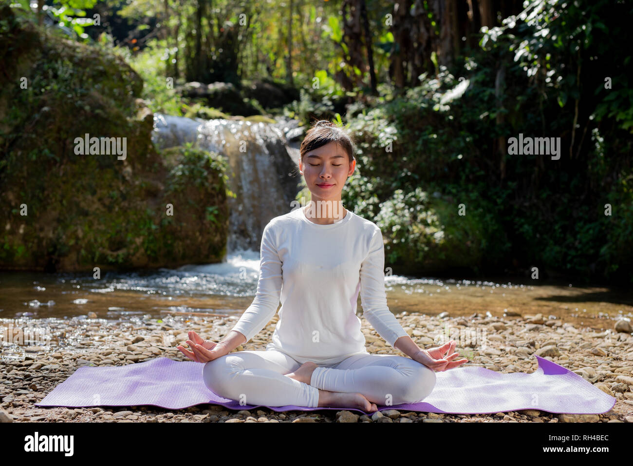 Beautiful girls are playing yoga at the park. Among the natural ...