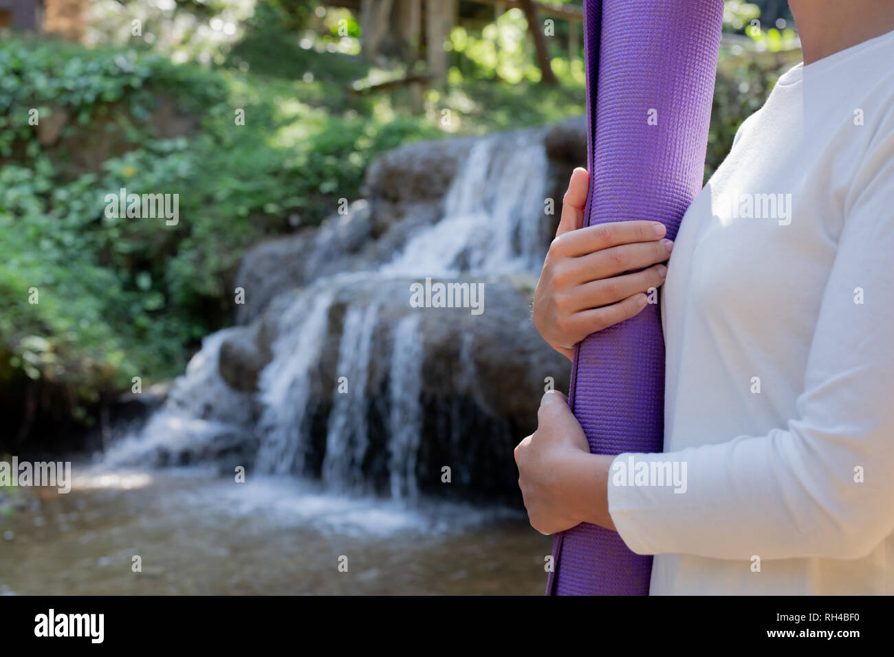 Woman yoga in front waterfall hi-res stock photography and images - Alamy