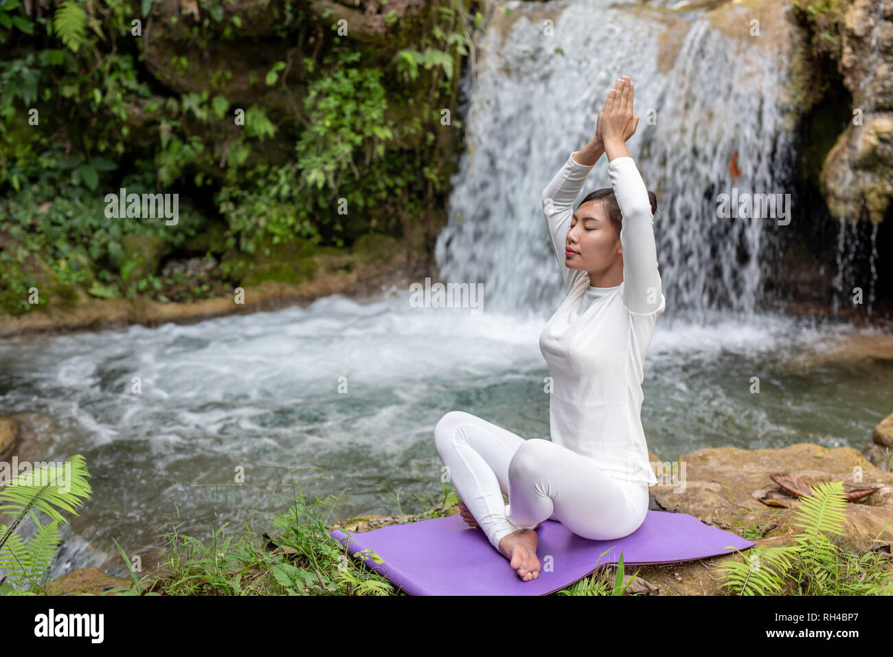 Beautiful girls are playing yoga at the park. Among the natural ...