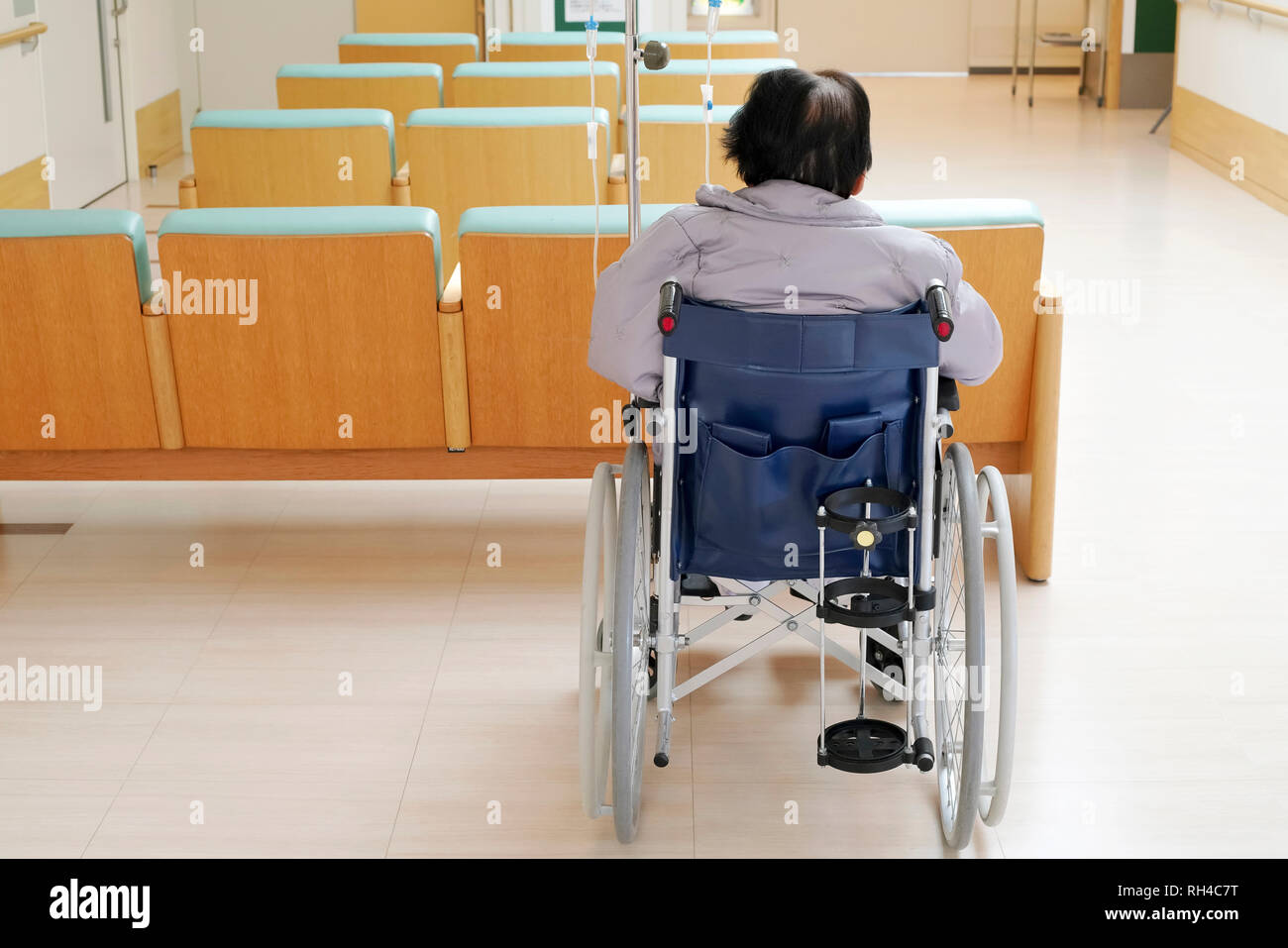 Back view of senior woman sitting on wheelchair in hospital Stock Photo