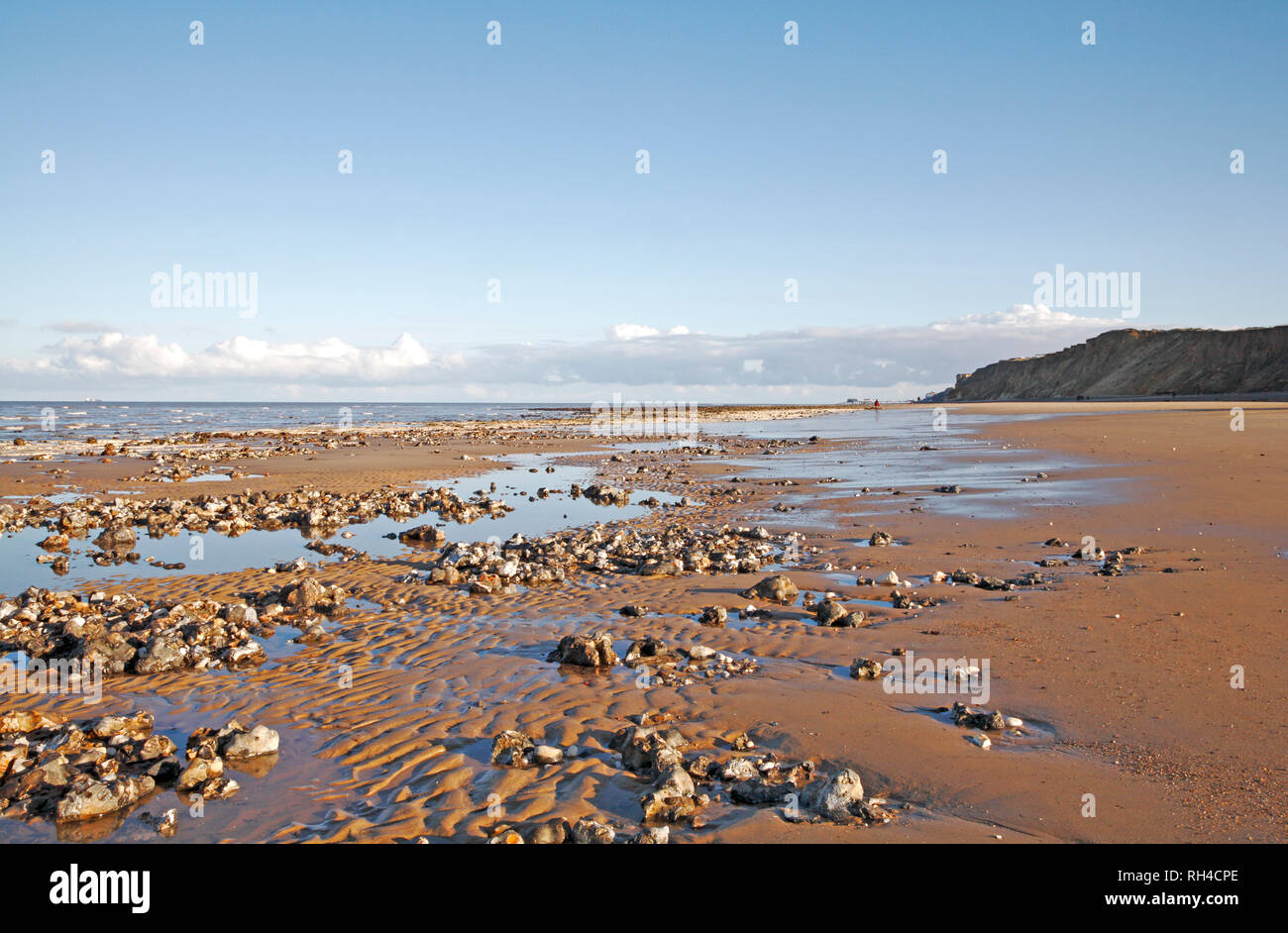 A view along the beach at low tide towards Cromer in North Norfolk from West Runton, Norfolk, England, United Kingdom, Europe. Stock Photo