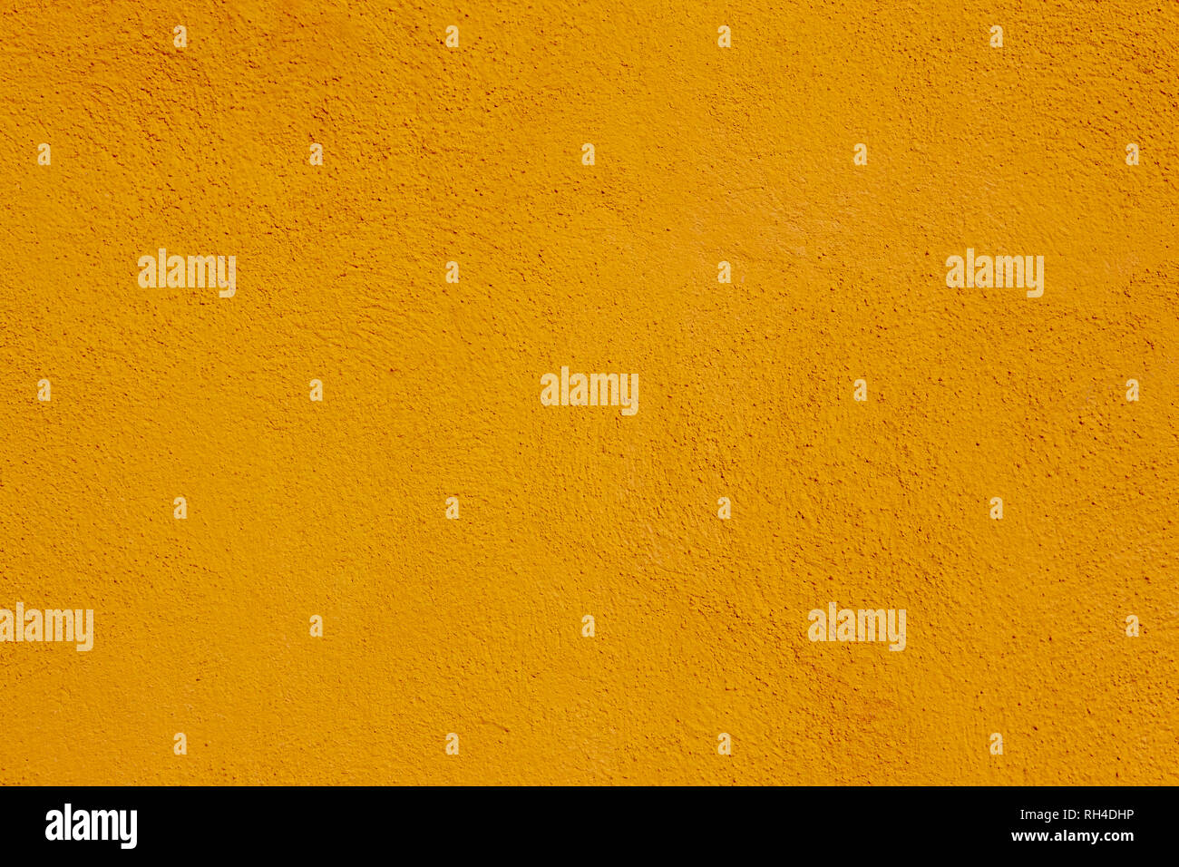 Warm yellow textured background. Concrete decorative surface