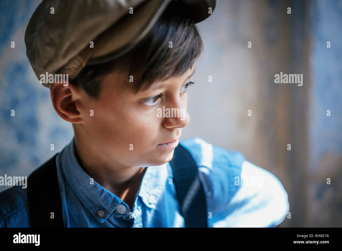 Thoughtful boy in cap looking away Stock Photo