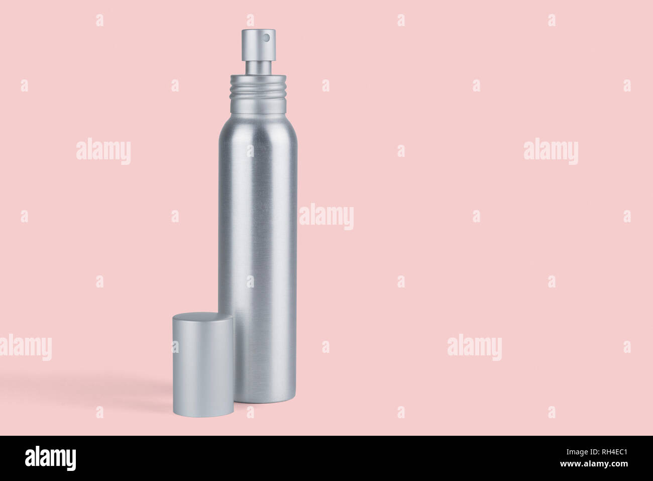 Metal spray bottle on pink background Stock Photo