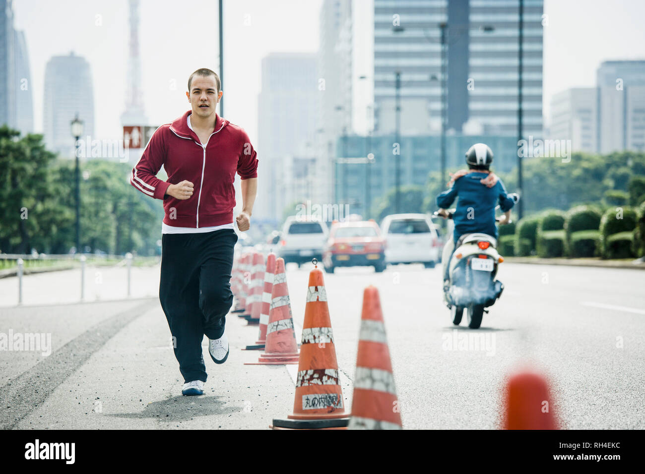 Young man jogging on urban street, Tokyo, Japan Stock Photo