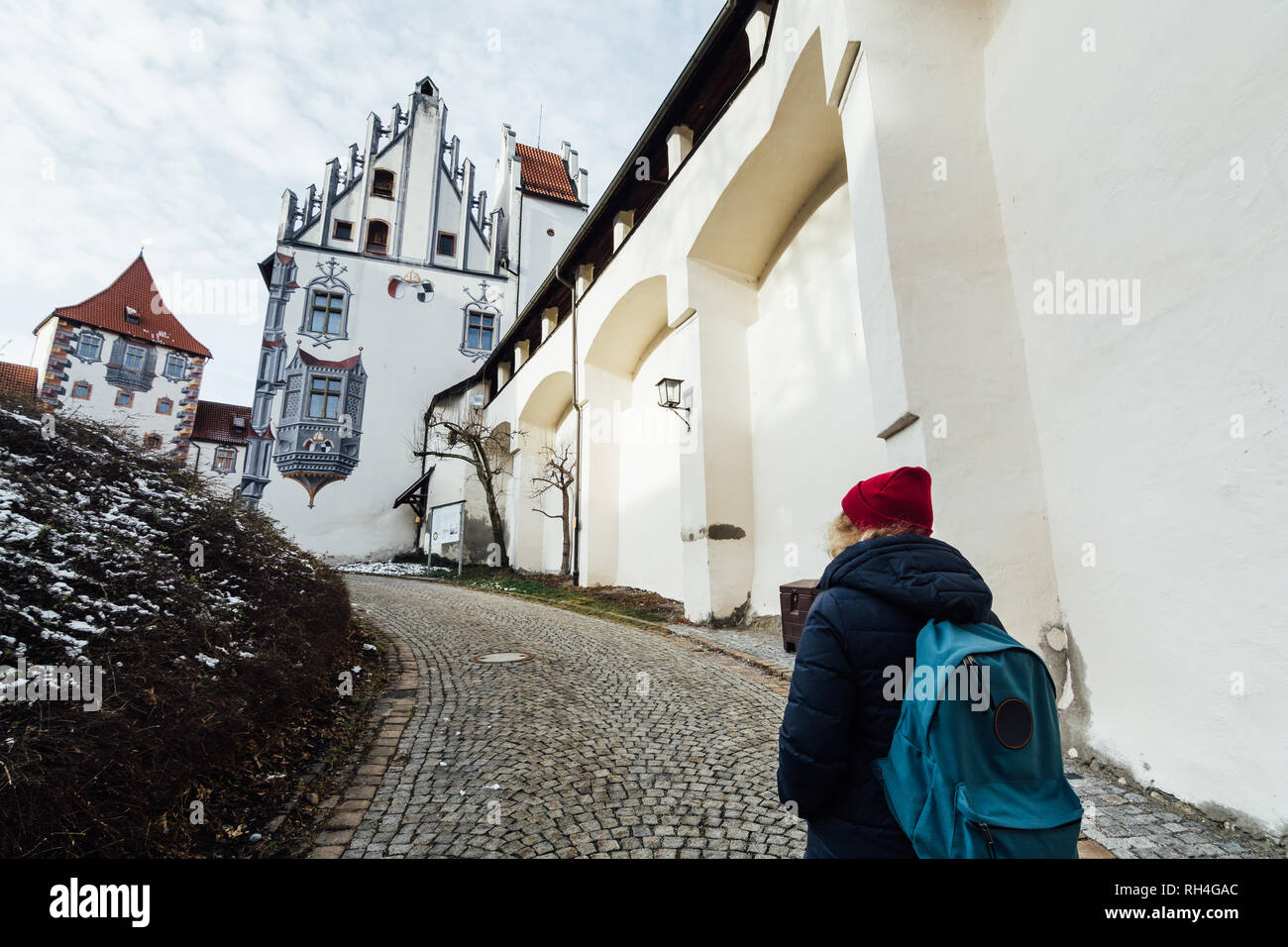 FUSSEN, GERMANY - DECEMBER 2018: woman standing at the entrance of Hohes castle. Stock Photo