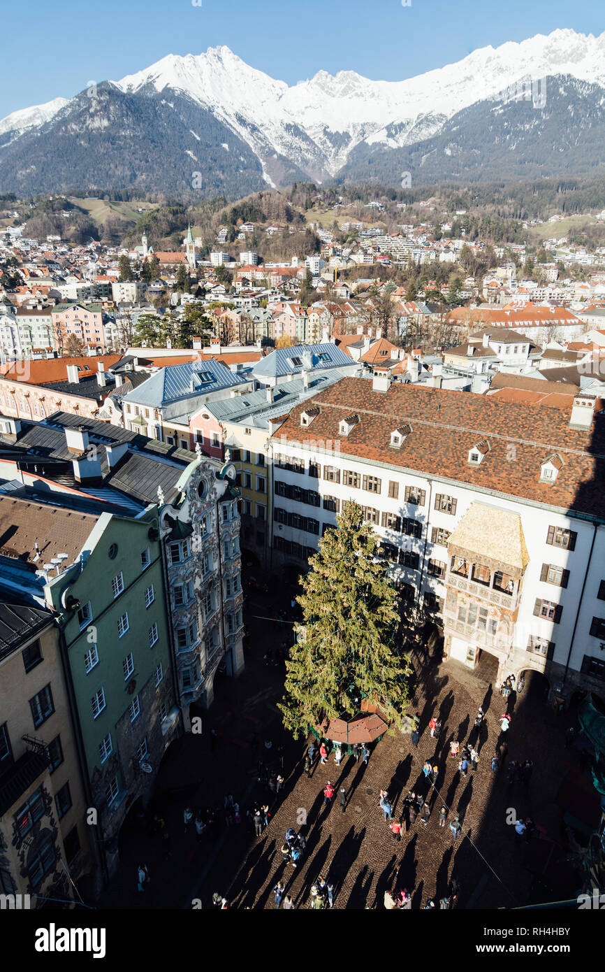 INNSBRUCK, AUSTRIA - DECEMBER 2018: view from Stadtturm tower over the town old center and Christmas tree on the market square. Stock Photo