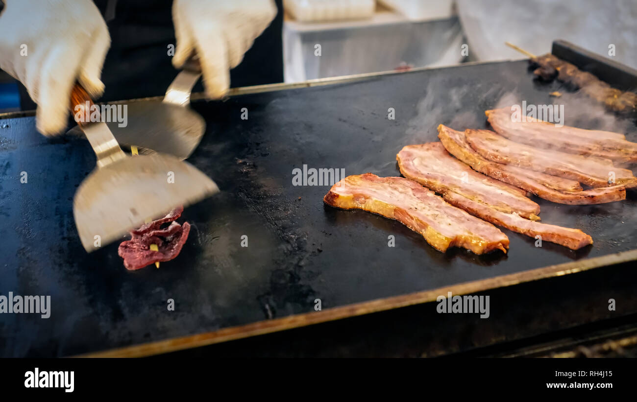 Meats cooking on a hot grill at a New Year’s Eve festival in Yokosuka, Japan. Stock Photo