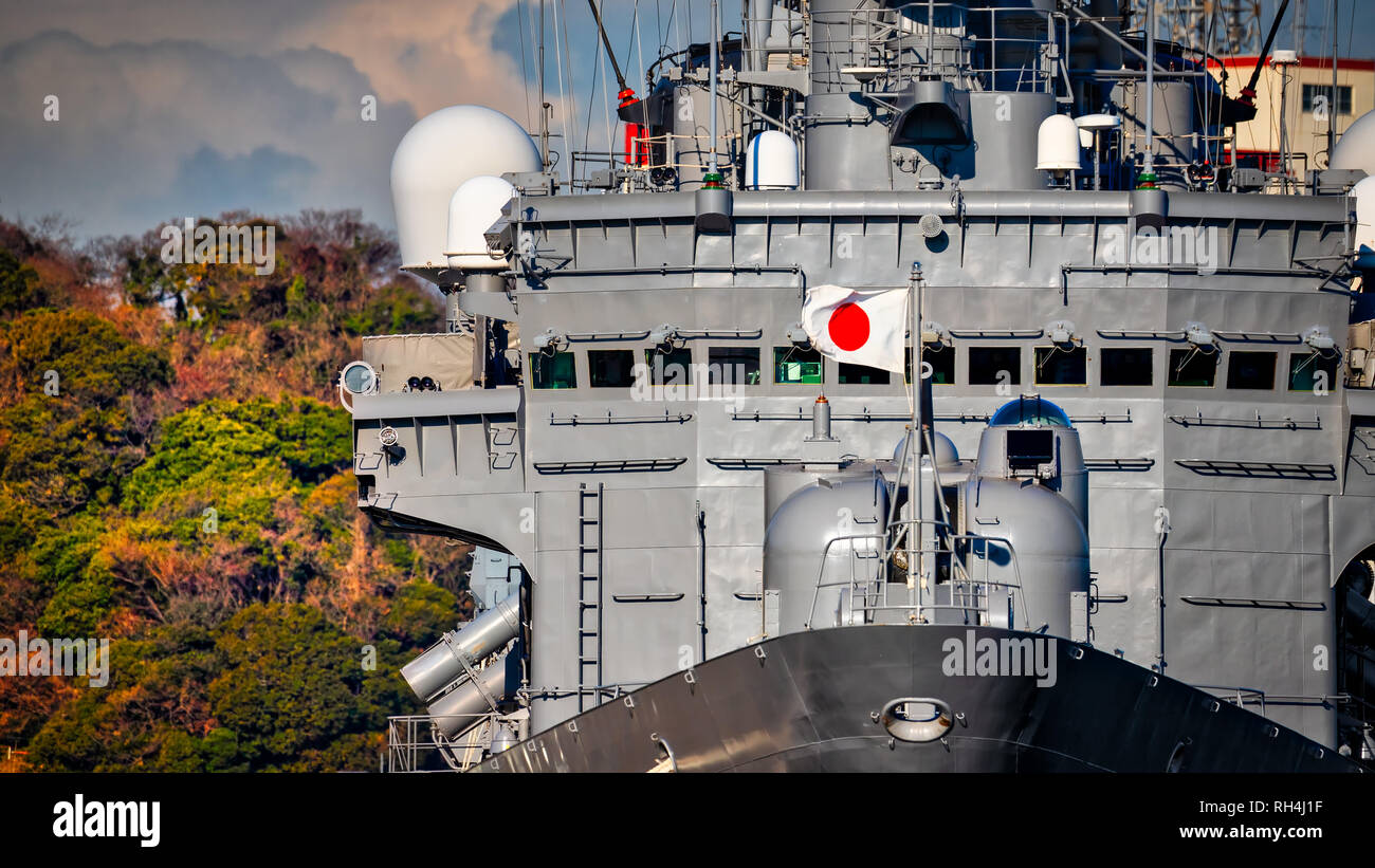 A heavy wind blows at the flag of a Japanese ship moored in Yokosuka, Japan. Stock Photo