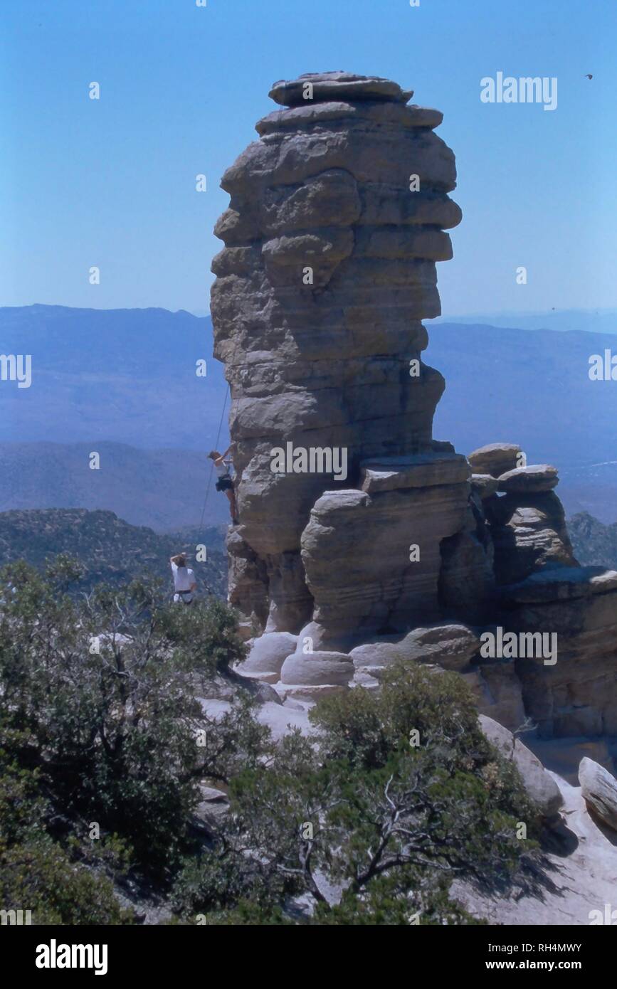 Mountain climbers climb a rock spindle on Mount Lemmon in Tucson