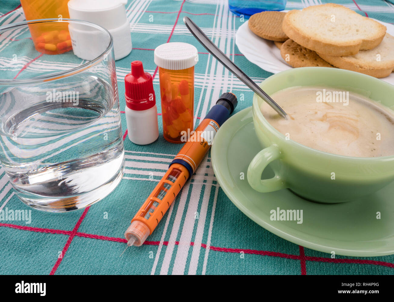 Medication during breakfast, injector of insulin together with a bottle ...