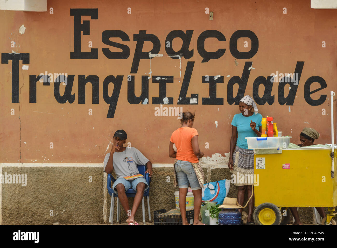 Cape Verde, Maio Island: street scene in the town of Vila di Maio (Porto Ingles), peddler and inscription 'Espaco tranquilidade', peaceful area Stock Photo