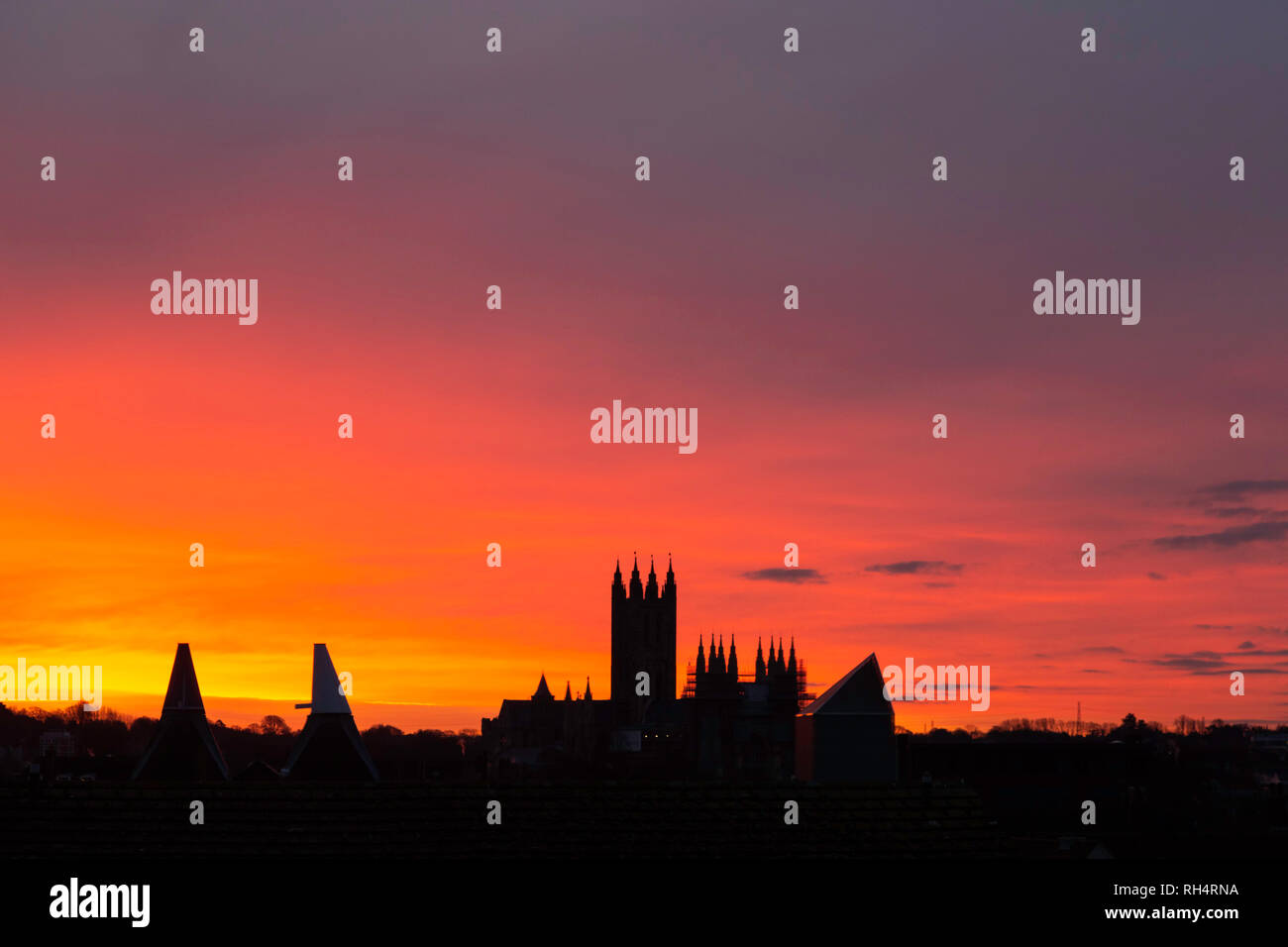 Dramatic pink dawn over Canterbury Cathedral and the Marlowe Theatre, Canterbury, Kent, UK. Stock Photo