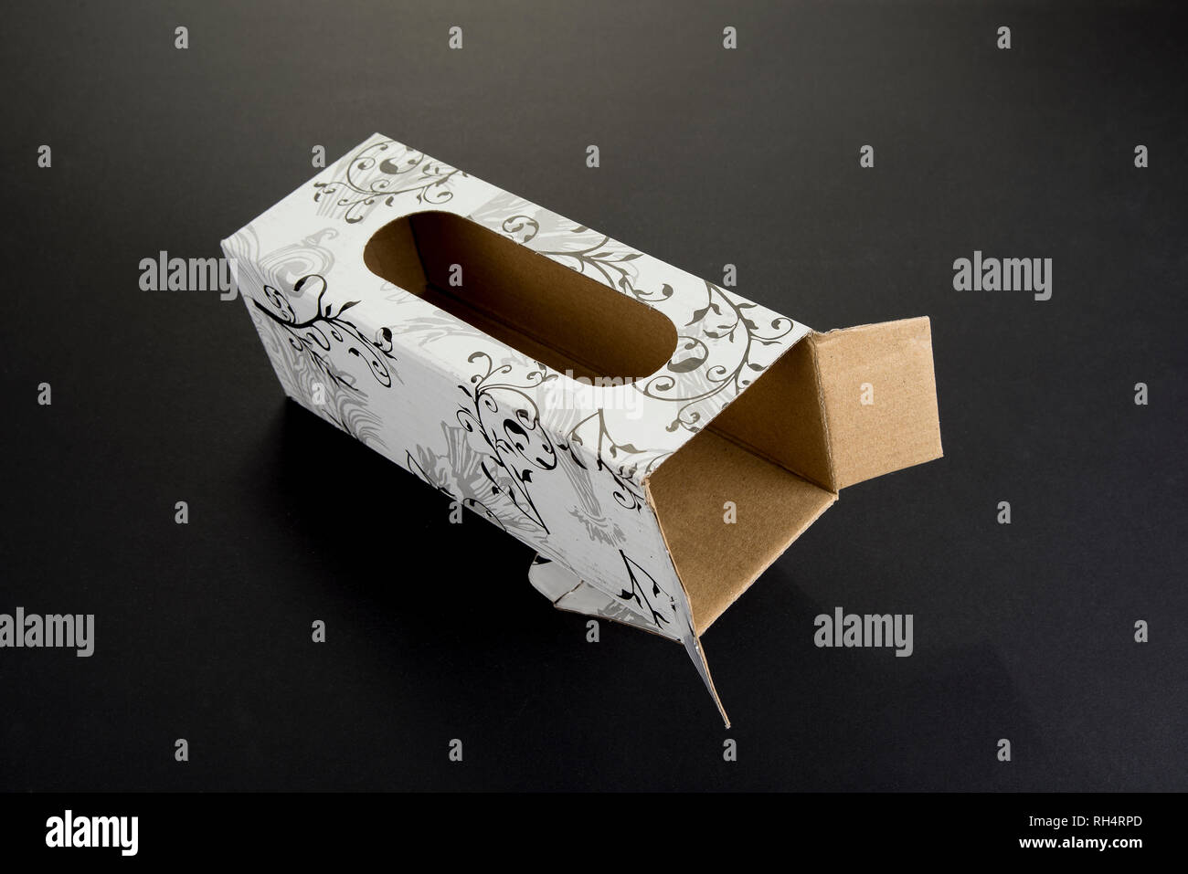 Empty cardboard box with ornaments and the hole Stock Photo
