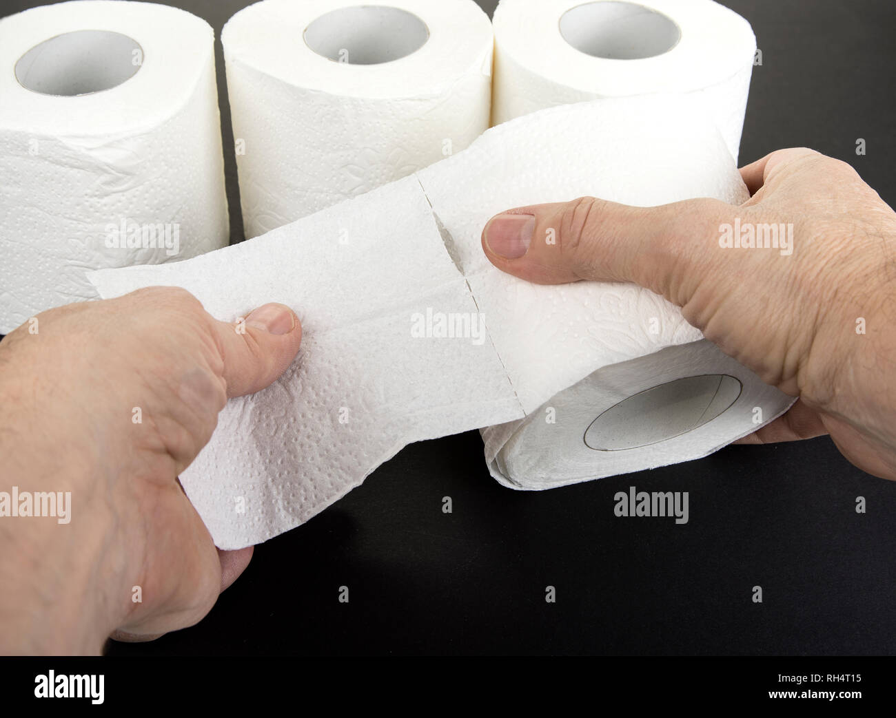 Two hands tear up toilet paper Stock Photo Alamy