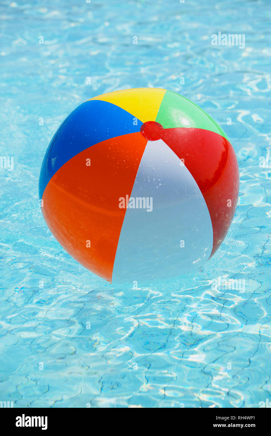 Colorfully inflated water ball floats in swimming pool Stock Photo