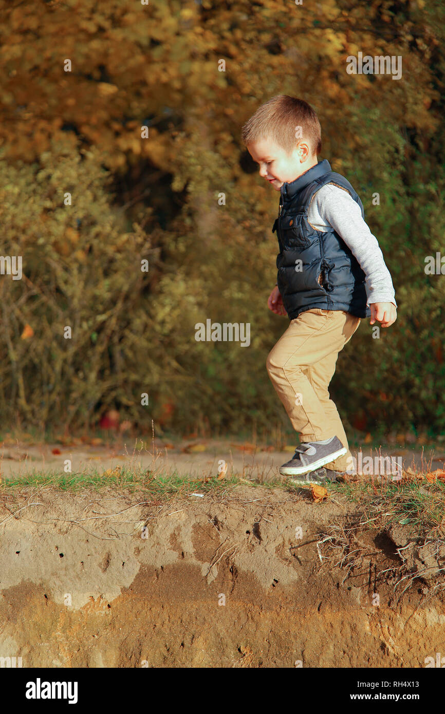 The Little Boy Walks Cautiously Up The Hill Stock Photo Alamy