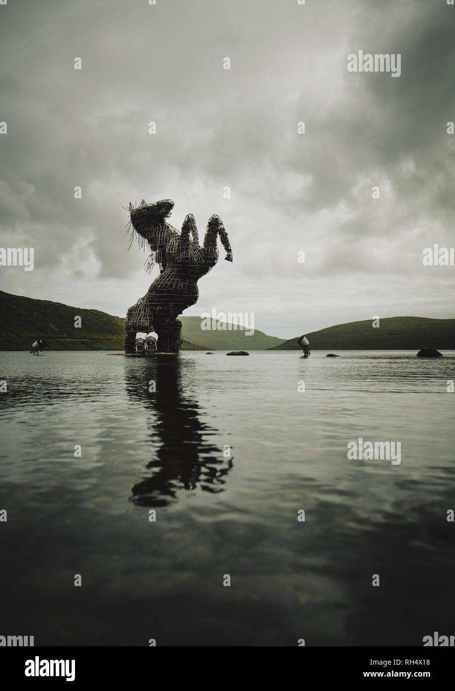 The silver statue of the mythical horse Nykur rising from Lake Sørvágsvatn on Vagar in the Faroe Islands. Stock Photo