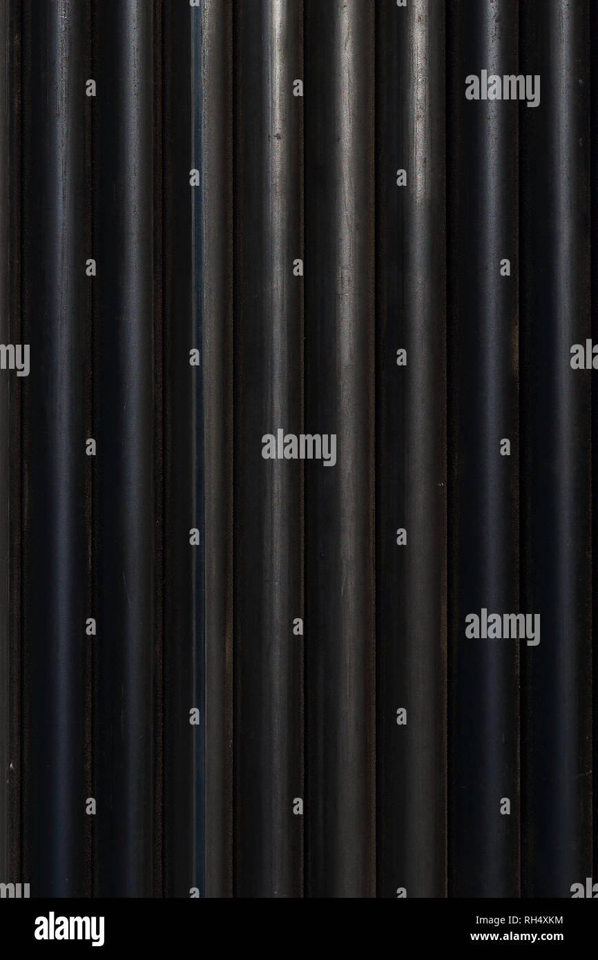 The carbon steel pipes were neatly aligned in a row. Stock Photo