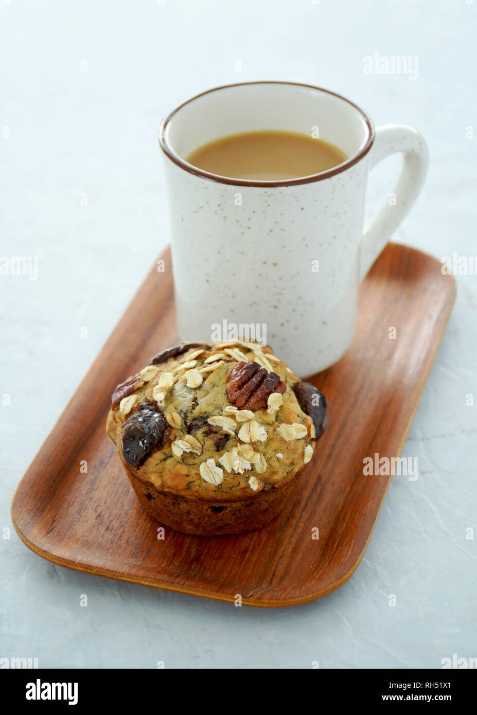 Fresh hot coffee and healthy pecan, oat, chocolate muffin for a ...