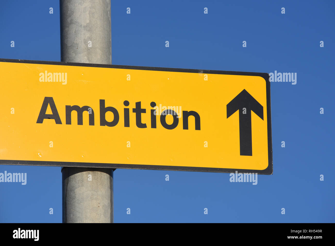 roadside roadsign arrow pointing to ambition project Stock Photo