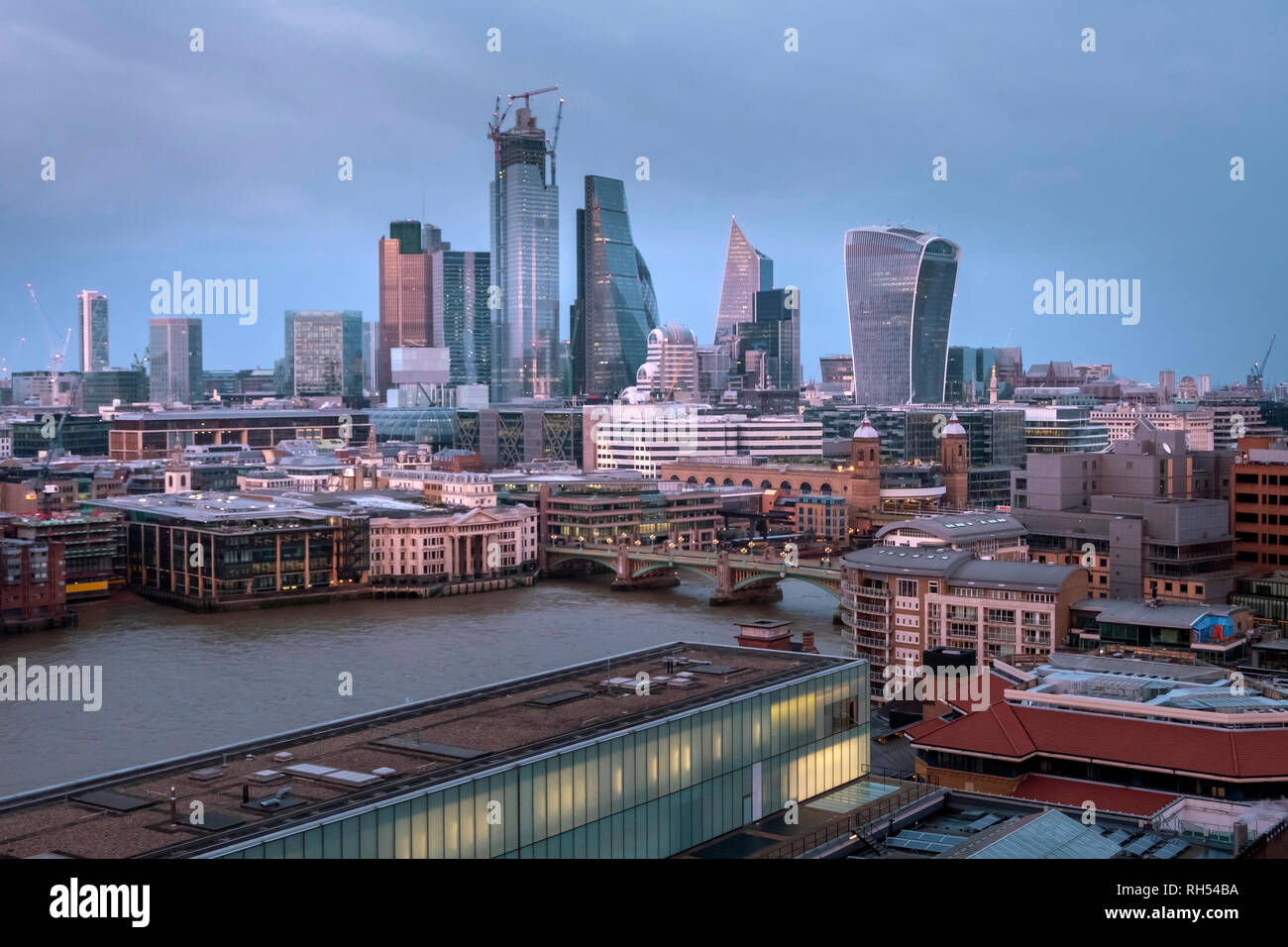 Panoramic view of London skyscrapers in the financial district in the evening, after sunset. View from Tate Modern museum. Stock Photo