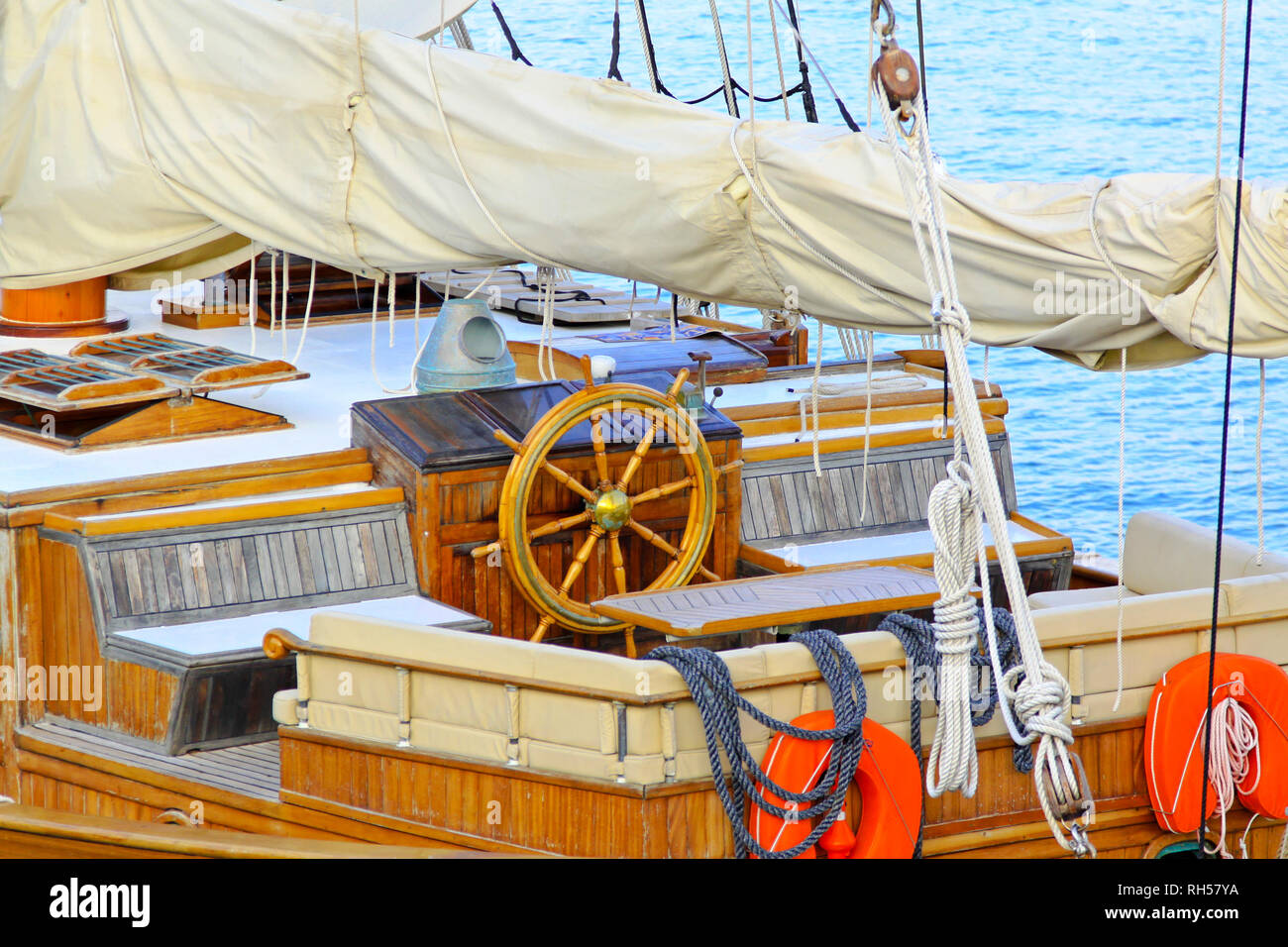 Old sail ship deck with wooden wheel Stock Photo - Alamy