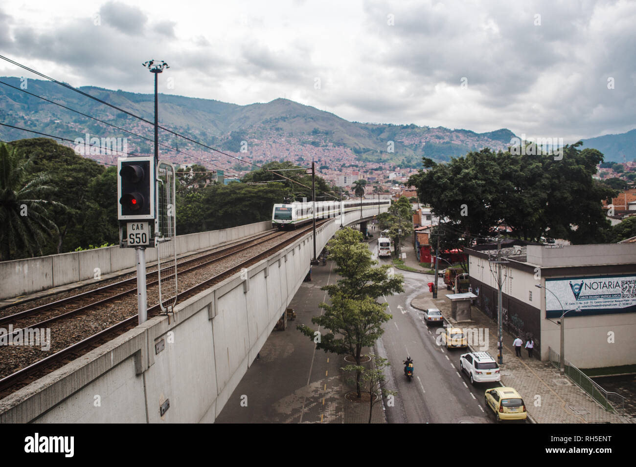 Public transport metro system bridge runs over a main road in Medellín Stock Photo
