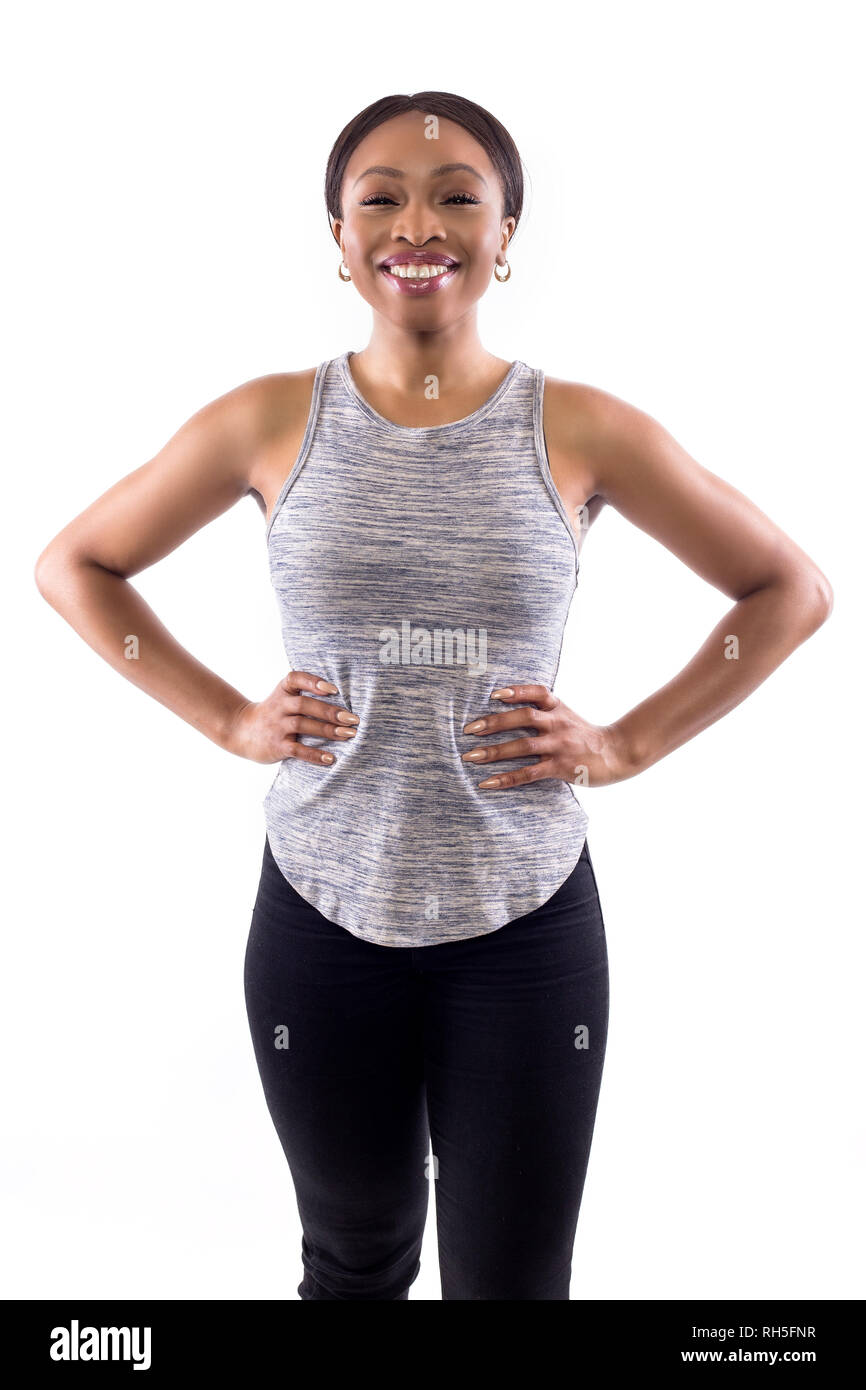Confident black female wearing athletic outfit on a white background as a  fitness trainer Stock Photo - Alamy
