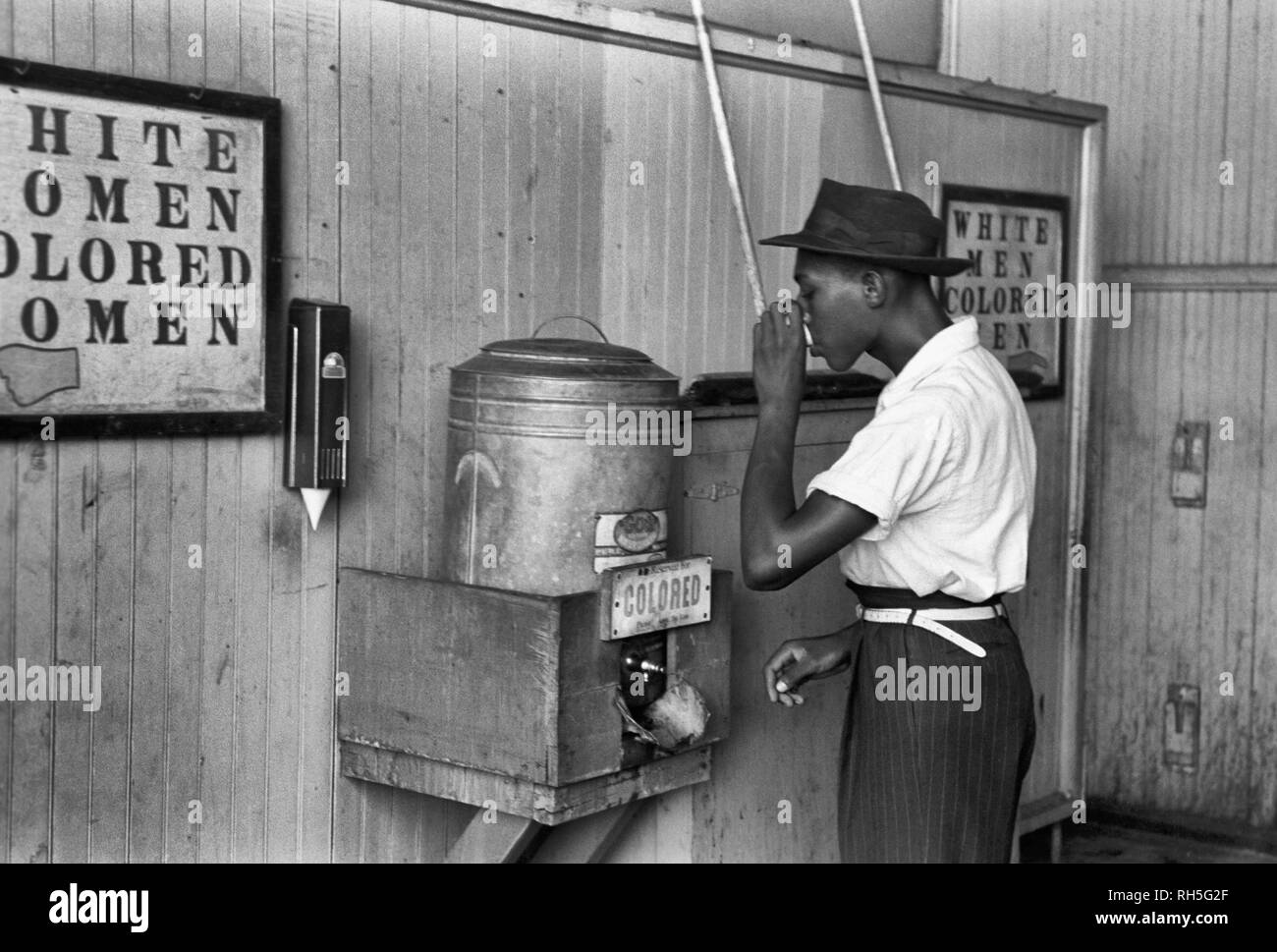 Drinking fountain from mid 20th century with african american drinking
