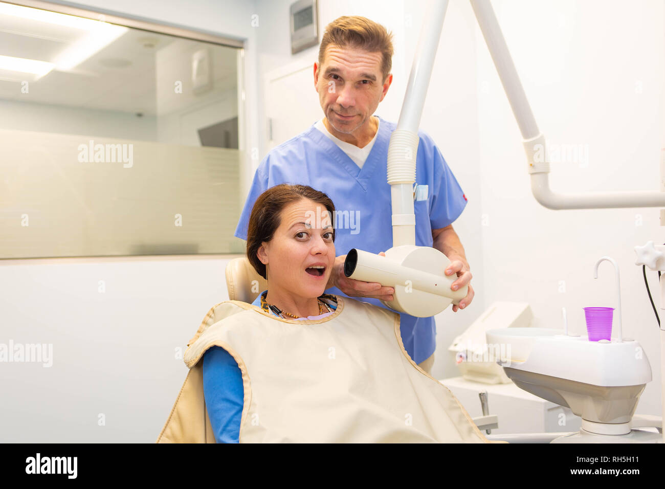 Dentist taking a teeth radiography to a patient in an office Stock Photo