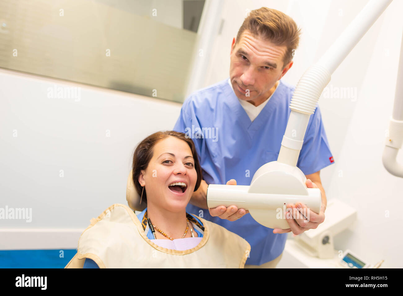 Dentist taking a teeth radiography to a patient in an office Stock Photo