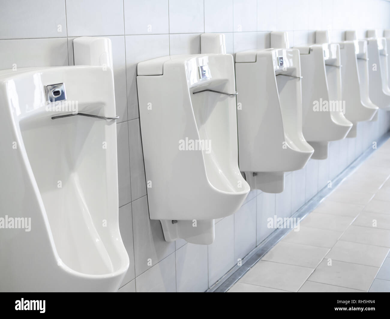Row of white clean urinals in men toilet Stock Photo Alamy