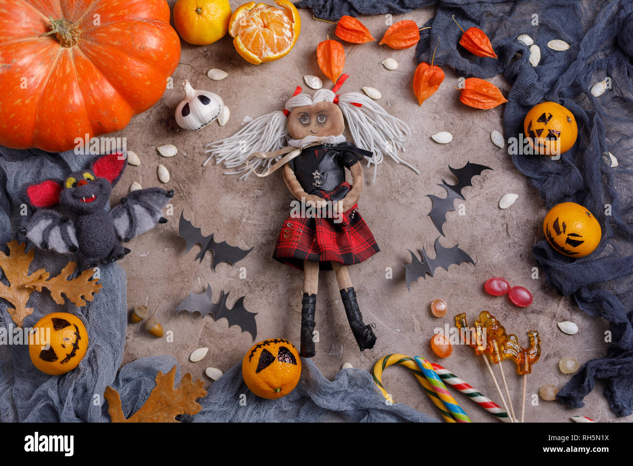 Table with sweets and toys, lollipops and decorated in honor of Halloween. Top view. Stock Photo