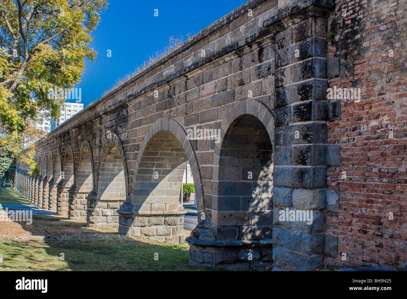 Arches of a stone aqueduct on a wonderful sunny day with a blue sky in Guadalajara Jalisco Mexico Stock Photo