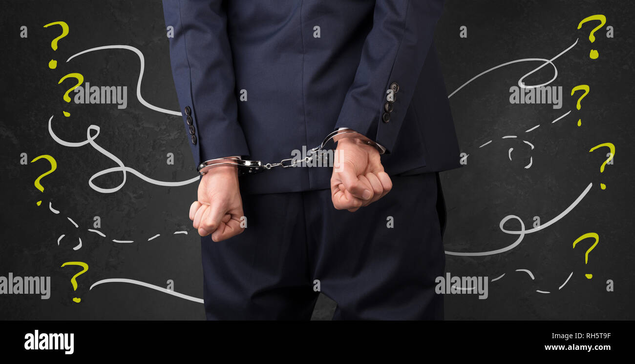 Now arrested men with handcuffs and chalk drawn question signs and