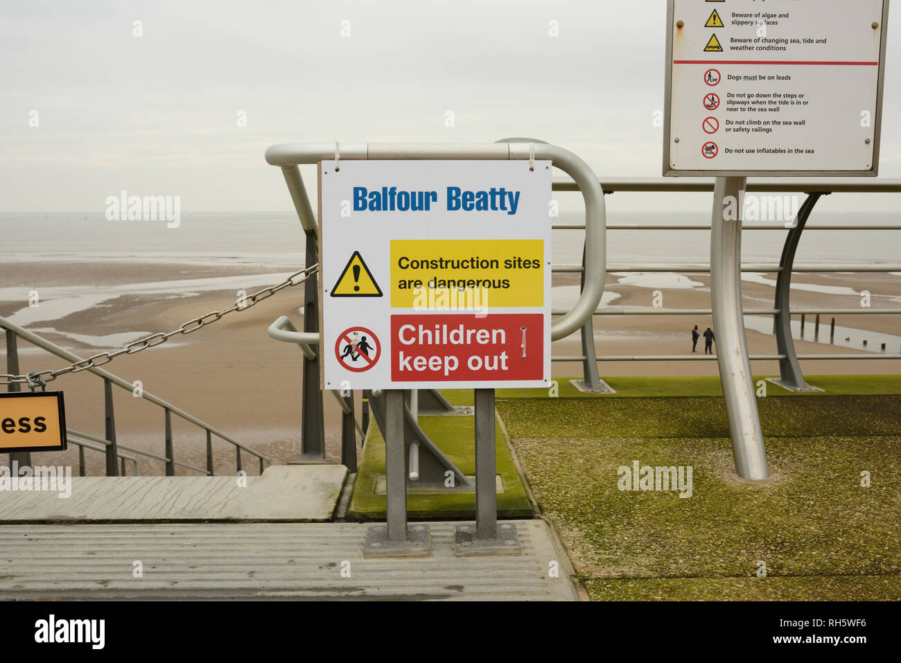 Warning sign children keep out, construction sites are dangerous, in overcast weather on Anchorsholme promenade, on the fylde coast in lancashire uk Stock Photo