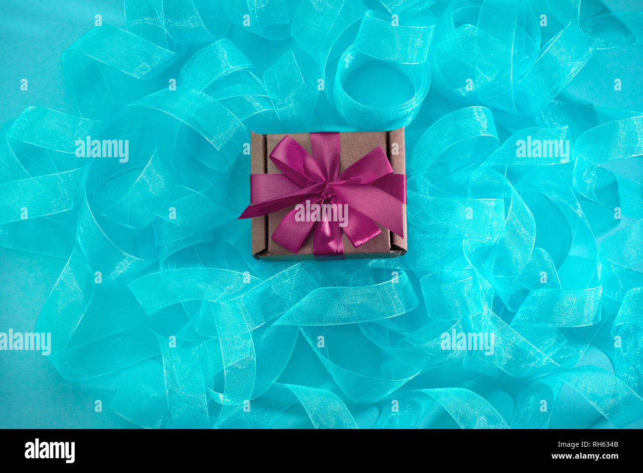 Abstract textured blue background. Ribbon curls top view Stock Photo