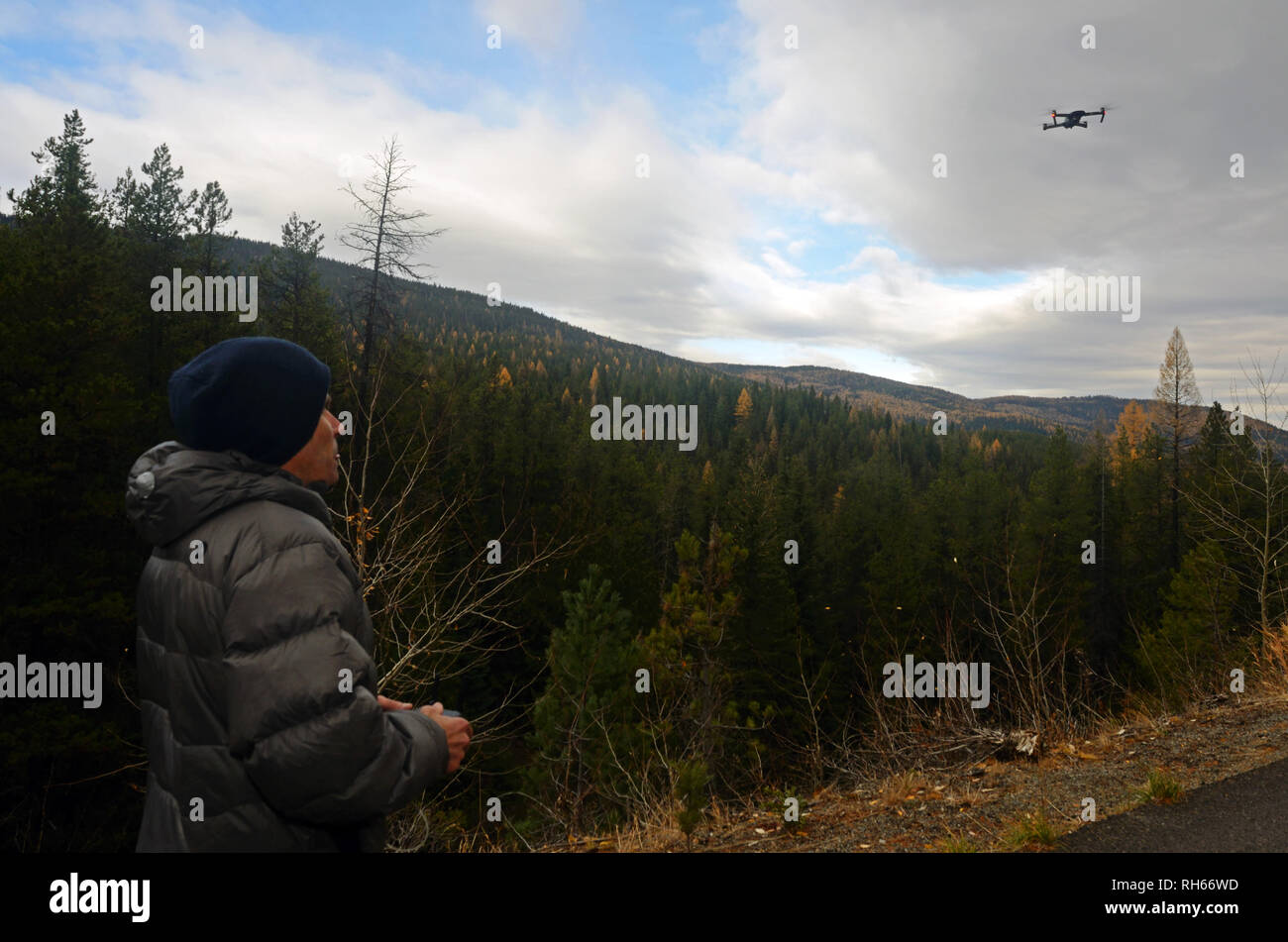 Filmmaker operates a DJI Mavic Pro drone during a videography session in the Purcell Mountains, Montana. (Photo by Randy Beacham) Stock Photo