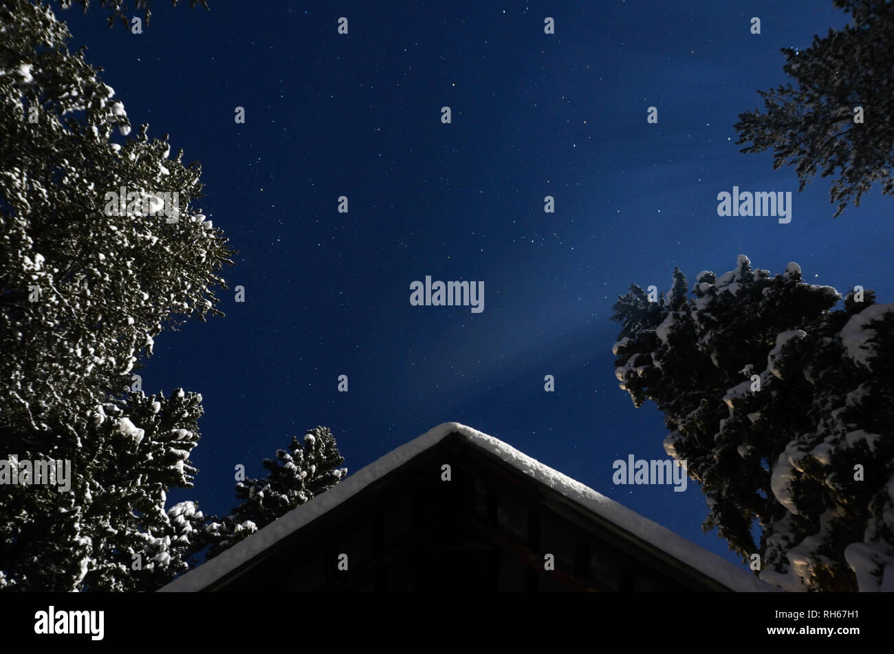 Night skies and cabin by moonlight after snowstorm in winter. Yaak Valley in the Purcell Mountains, northwest Montana. (Photo by Randy Beacham) Stock Photo